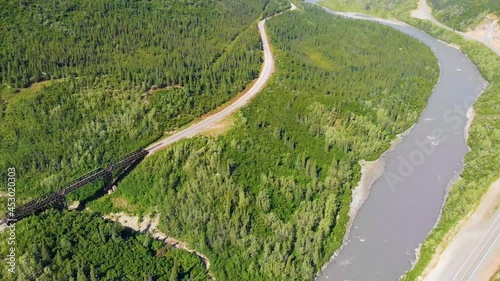 4K Drone Video of Train Trestle bridge and Mountains Rising above the Chulitna River near Denali National Park and Preserve, AK during Summer photo