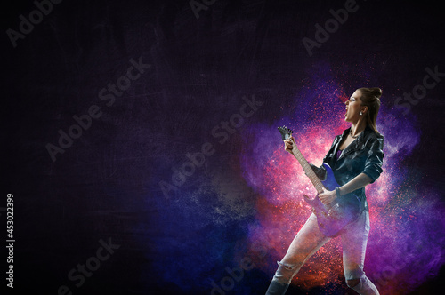 Young and beautiful rock girl playing the electric guitar © Sergey Nivens