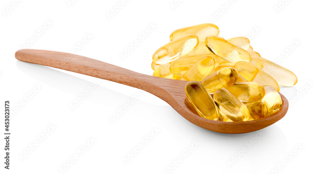 Fish oil capsules in a spoon