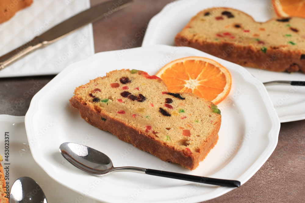 Slice of Delicious Homemade English Fruit Cake Loaf Pudding with Dried Mixed Fruit, Sultanas, Raisins, and Chopped Almond. Served during Christmas Party or New Year Eve