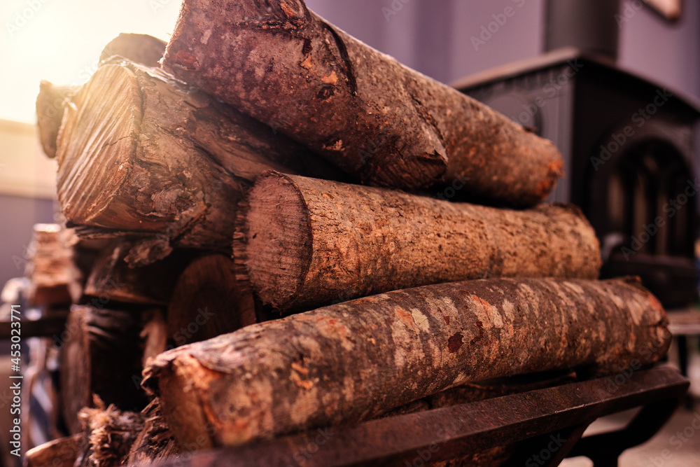A wood stove and firewood on a cozy Maine Morning A wood stove and firewood on a cozy Maine Morning