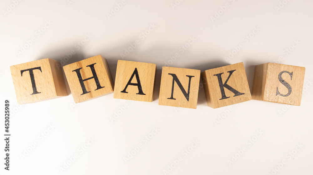 Obraz premium The word Thanks was created from wooden cubes.