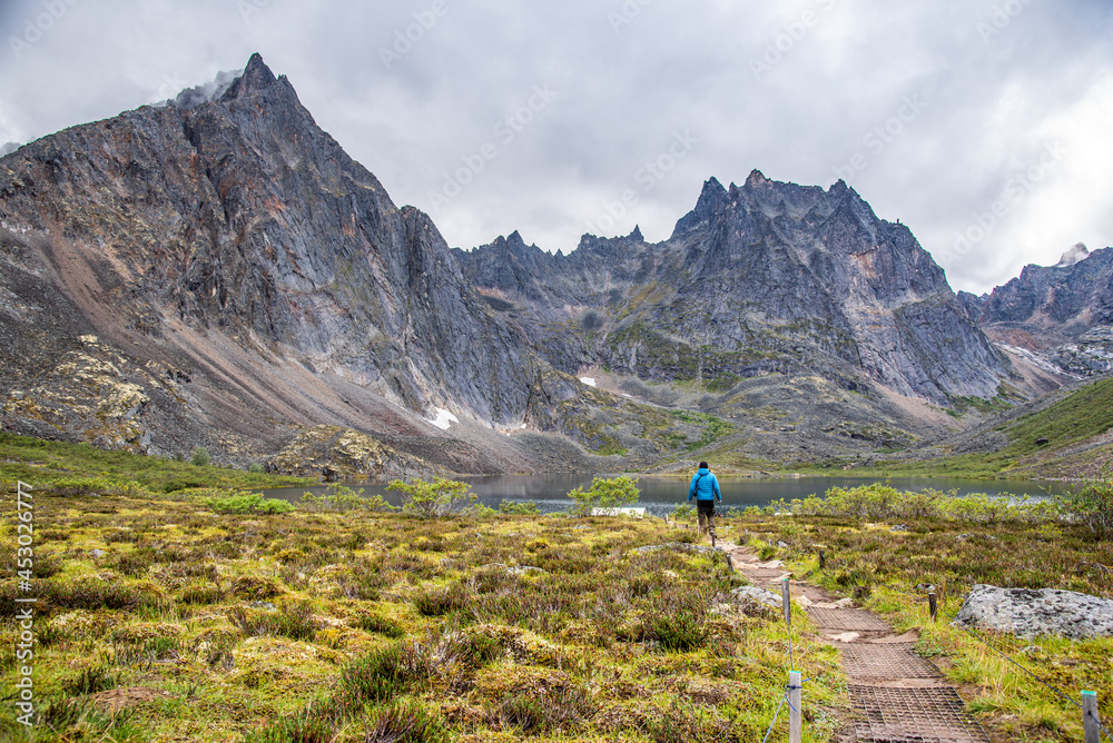 Hiking in Tombstone Territorial Park during summer time with amazing peaks in background. 