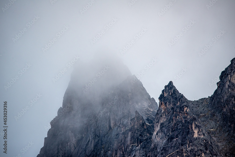 Cloudy, foggy mountain peaks in northern Canada, Yukon Territory during summer time with white, misty backgroumd. 
