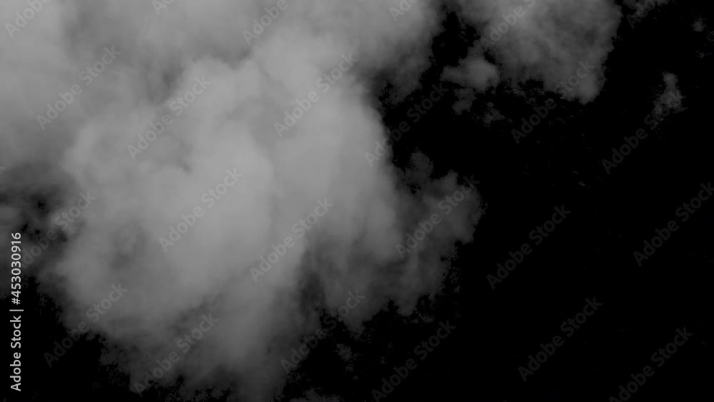 Spooky magic Halloween. Atmospheric smoke VFX element. Haze background. Abstract smoke cloud. Smoke in slow motion on black background. White smoke slowly floating through space against black bg Spooky magic Halloween. Atmospheric smoke VFX element. Haze background. Abstract smoke cloud. Smoke in slow motion on black background. White smoke slowly floating through space against black bg