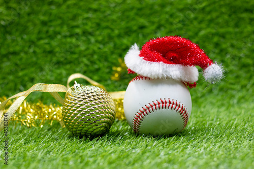 Baseball with Christmas Holiday Decoration on green grasss