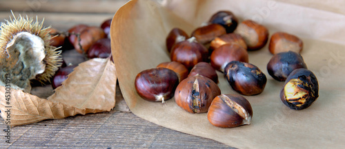 closeup on roasted chestnuts on a paper on a table