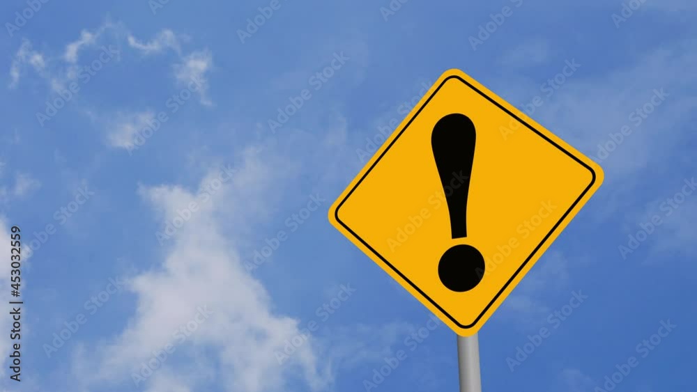 Exclamation Mark Road Sign on Clear Blue Sky with Rapid Moving Clouds for Text Placement Exclamation Mark Road Sign on Clear Blue Sky with Rapid Moving Clouds for Text Placement