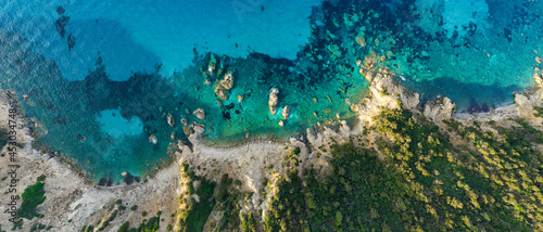View from above  stunning aerial view of a green and rocky coastline bathed by a turquoise  crystal clear water. Costa Smeralda  Sardinia  Italy.