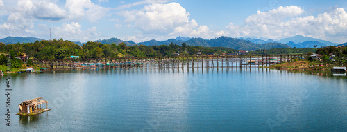 Beautiful view Panorama of sunrise Old wooden bridge at Sangklaburi at Kanchanaburi province in Thailand.  photo