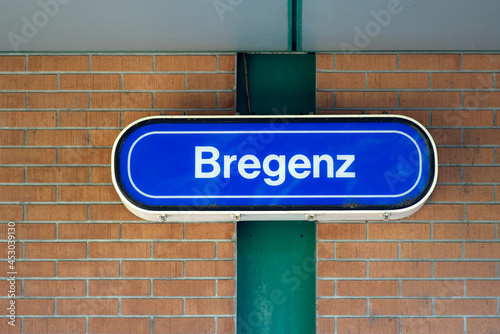 Sign at train station of Bregenz with red brick wall in the background on a sunny summer day. Photo taken August 14th, 2021, Bregenz, Austria. photo