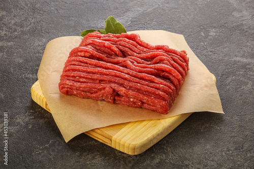 Raw beef minced meat over board