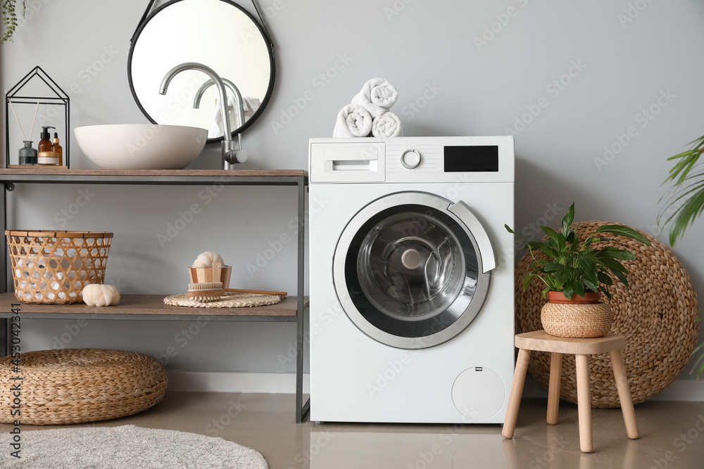 Modern washing machine in bathroom Modern washing machine in bathroom