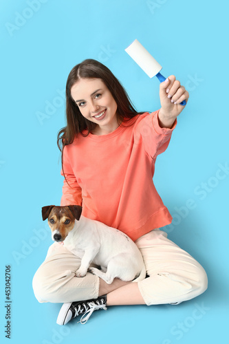 Young woman with lint rolle...
