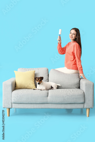 Young woman with lint rolle...