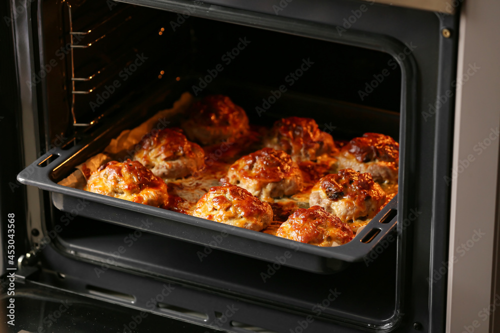 Baking tray with delicious minced meat boats, mushrooms and melted cheese in oven Baking tray with delicious minced meat boats, mushrooms and melted cheese in oven