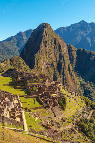 Machu Picchu inca ruin in vertical format, summer season, Cusco region, Peru.