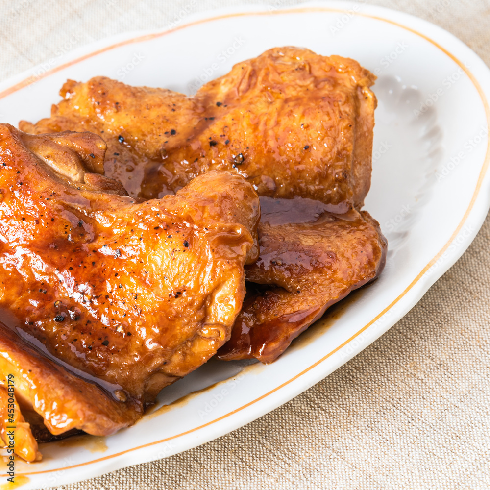 Fried chicken pieces with teriyaki sauce, close-up Fried chicken pieces with teriyaki sauce, close-up