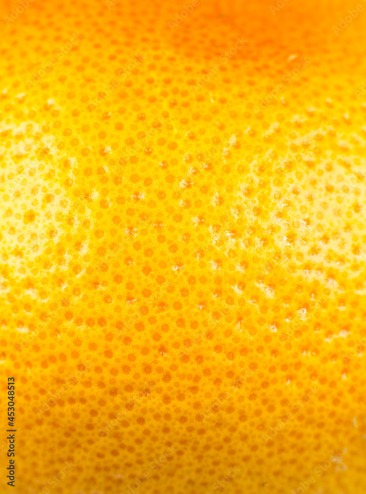 Close up photo of Grapefruit peel texture. Exotic ripe fruit, orange background, macro view. Human skin problem concept, acne and cellulite. Beautiful nature wallpaper.