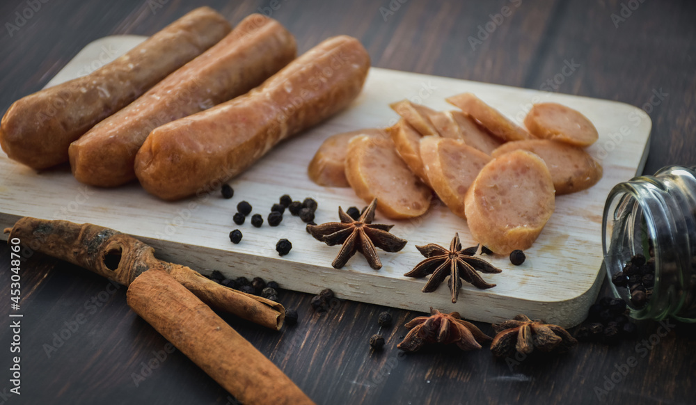 Sausage Or Guan Chiang and Herbs on the board, serving good beer snacks on a dark background. Sausage Or Guan Chiang and Herbs on the board, serving good beer snacks on a dark background.