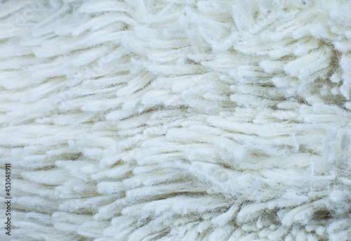 White cotton towel or carpet.fluffy texture background. Close up, macro photo. Soft focus image.