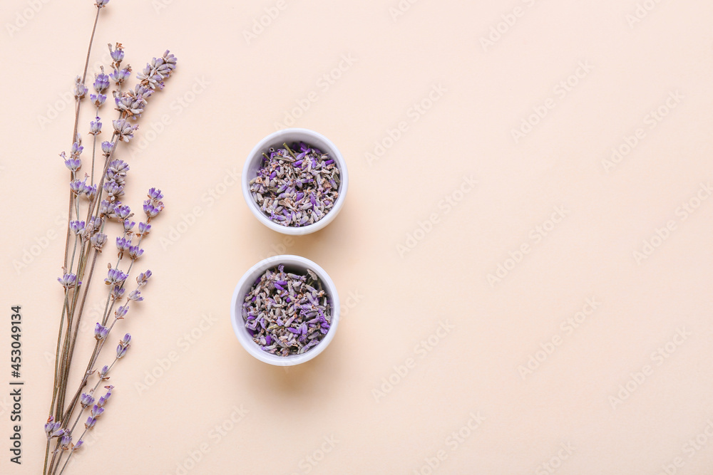 Fototapeta Bowls with lavender flowers on color background