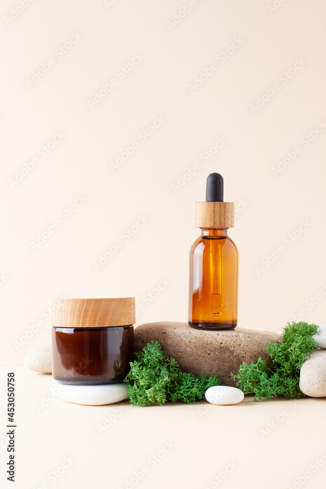 Cosmetic skin care products with stones and moss on pastel beige background. Close up, copy space Cosmetic skin care products with stones and moss on pastel beige background. Close up, copy space