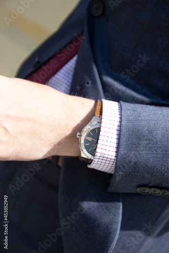 hand of a man. a man in a business suit with a watch