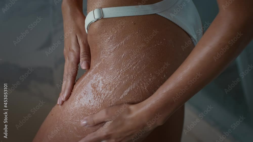 Unrecognizable Woman Applying Scrub On Hips Caring For Skin Indoor