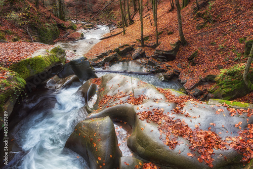 Amazing nature landscape with mountain creek and bizarre stones in the colorf...