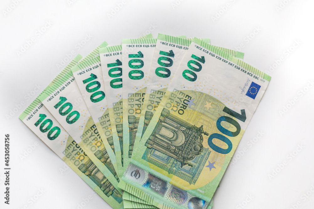 One hundred euro banknotes money, european currency on a white background. One hundred euro banknotes money, european currency on a white background.