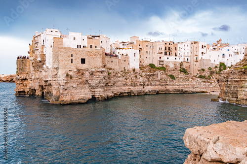Polignano a Mare. Town on the cliffs, Puglia region, Italy, Europe. Traveling concept background with old traditional houses, dramatic sky, Mediterranean Sea