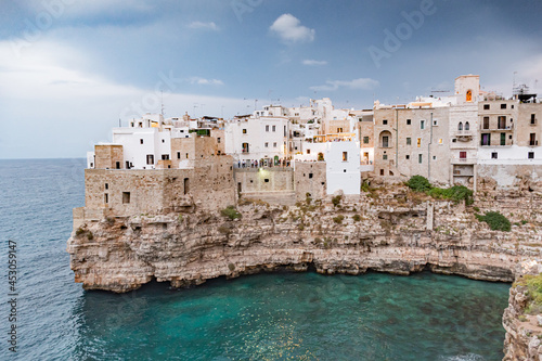 Polignano a Mare. Town on the cliffs, Puglia region, Italy, Europe. Traveling concept background with old traditional houses, dramatic sky, Mediterranean Sea