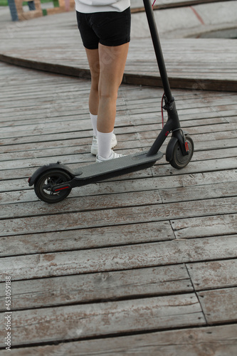 Electric scooter and girl's legs.