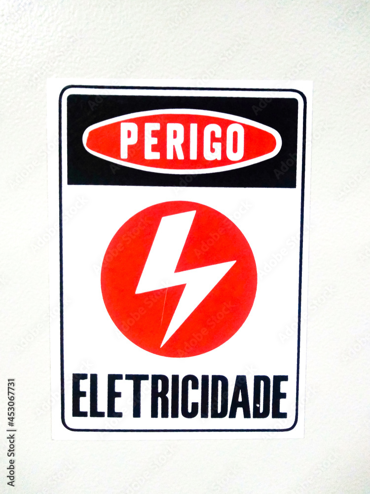 Electricity danger sign, written in Portuguese, on white background. Electricity danger sign, written in Portuguese, on white background.