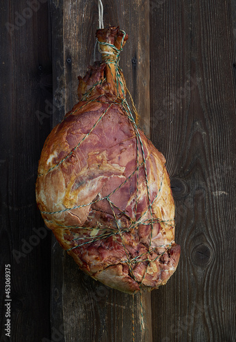 Smoked pork ham on wooden background