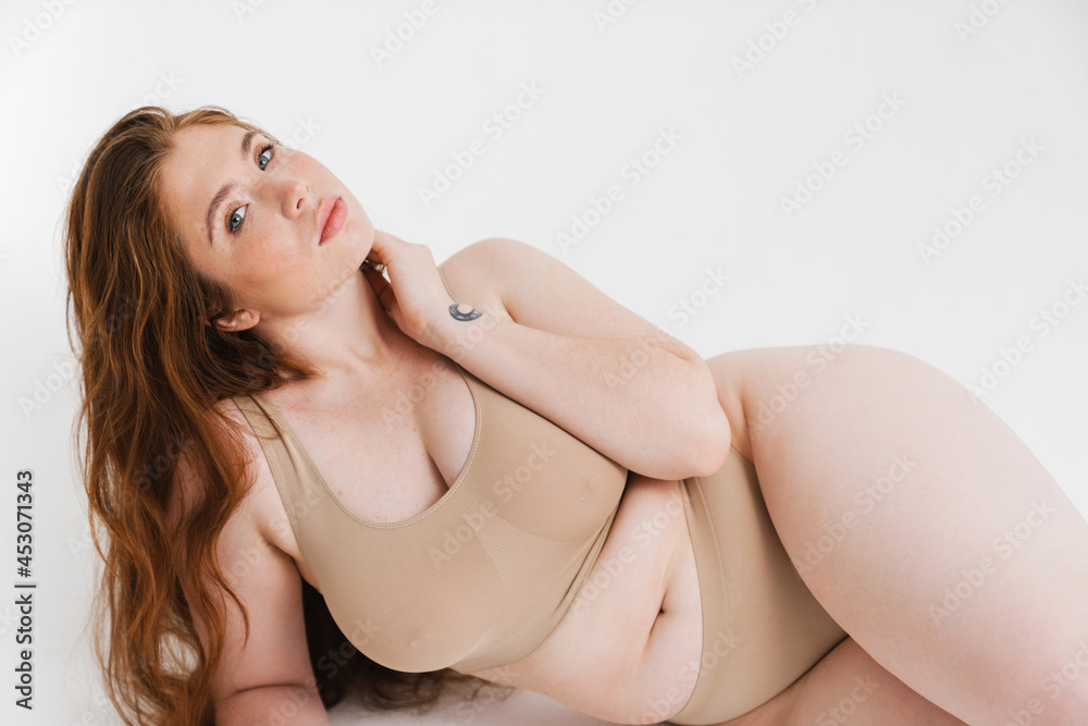 Young white plus size woman in lingerie posing Stock Photo