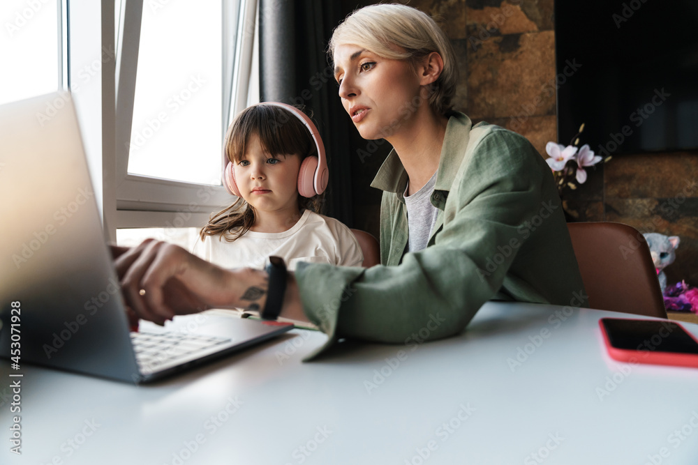 Mother helping her daughter with her homework Mother helping her daughter with her homework