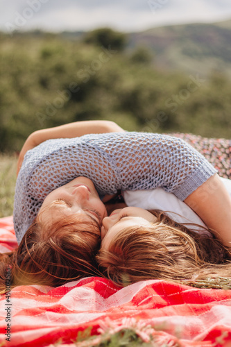 Girls on a red bedspread