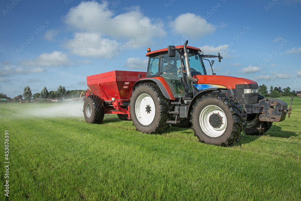 Fertilizer spreader. Fertilizer. Tractor. Farming. Meadow. Grass. Chalk. Netherlands Fertilizer spreader. Fertilizer. Tractor. Farming. Meadow. Grass. Chalk. Netherlands