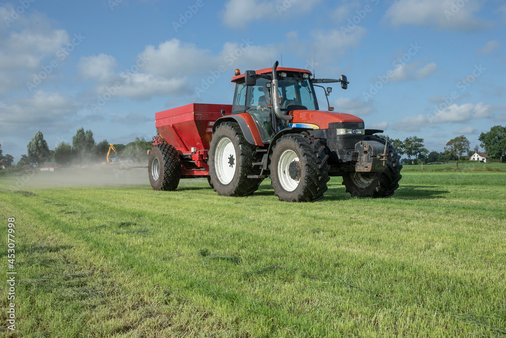 Fertilizer spreader. Fertilizer. Tractor. Farming. Meadow. Grass. Chalk. Netherlands Fertilizer spreader. Fertilizer. Tractor. Farming. Meadow. Grass. Chalk. Netherlands