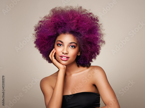 Beauty portrait of African American girl with colorful dyed afro hair. Beautiful black woman. Cosmetics  makeup and fashion
