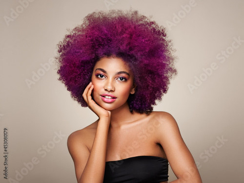 Beauty portrait of African American girl with colorful dyed afro hair. Beautiful black woman. Cosmetics, makeup and fashion