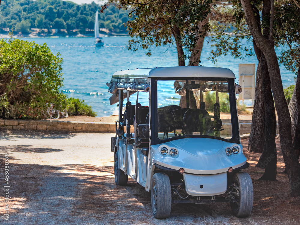 electric car for transporting tourists on a background of the sea