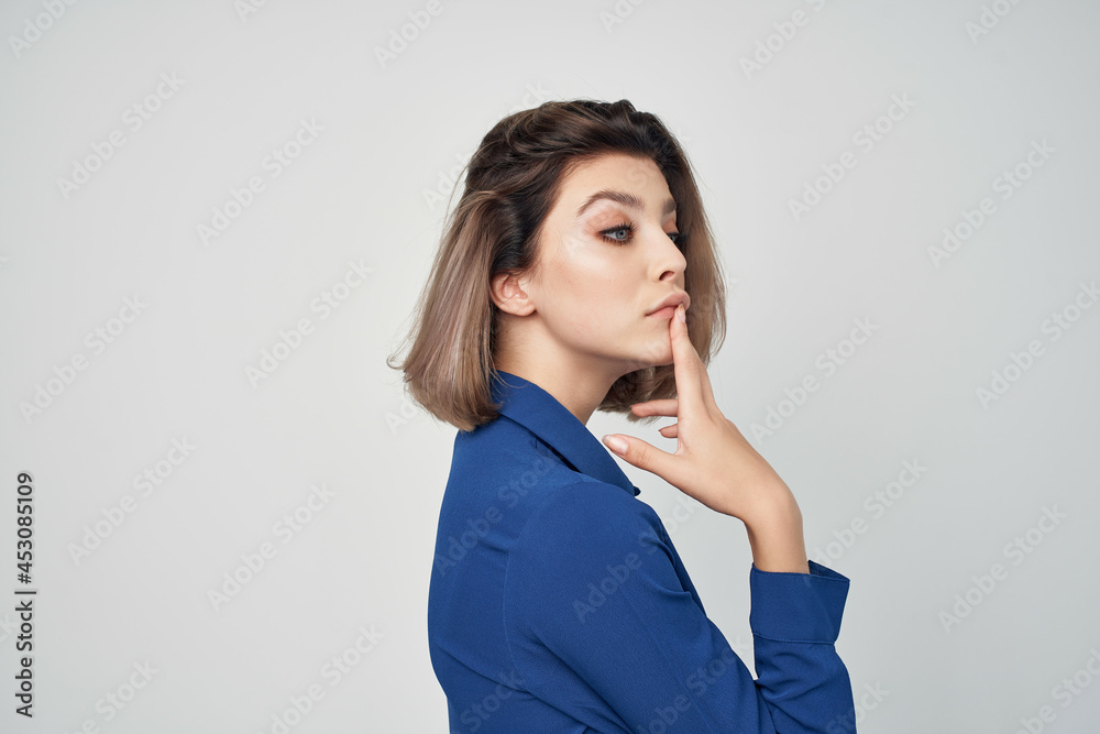 woman in blue shirt wearing glasses fashion cropped view light background
