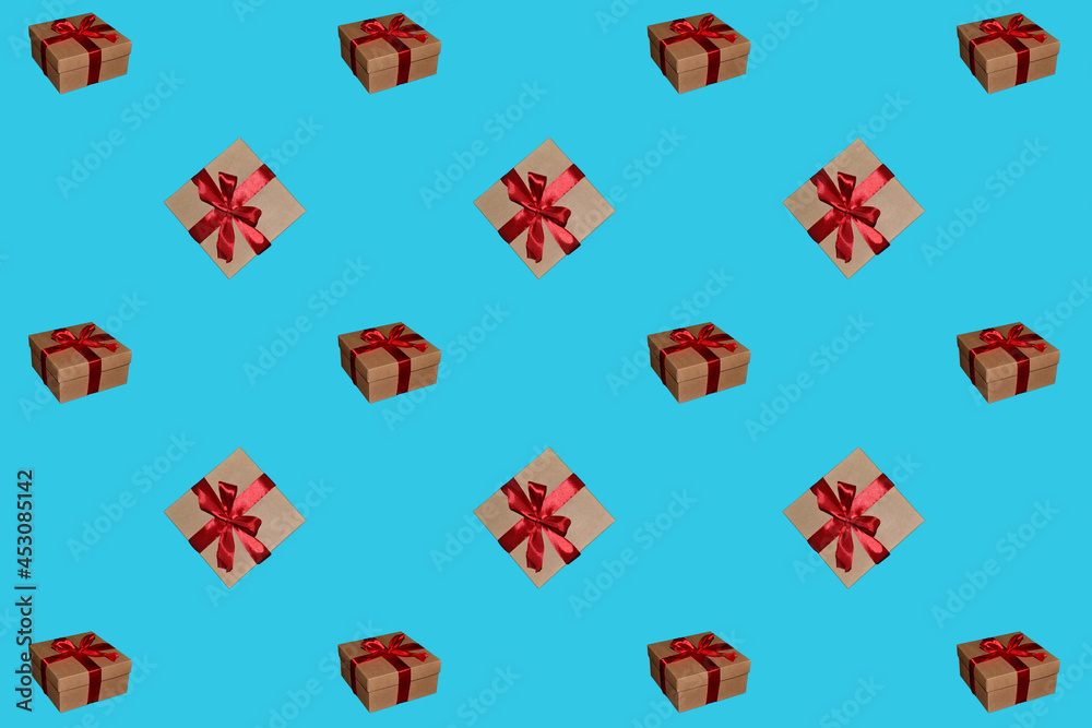 Pattern of gift boxes with a bow made with ribbon isolated on a light blue background