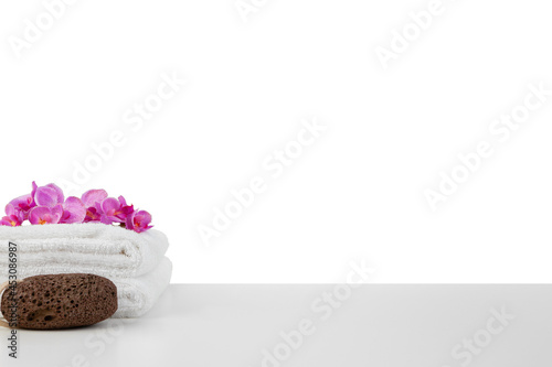 Spa composition with towels and flowers isolated on white