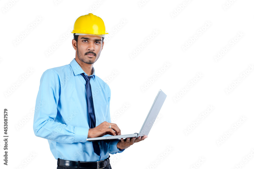 young Indian engineer in uniform and using laptop on white background. young Indian engineer in uniform and using laptop on white background.