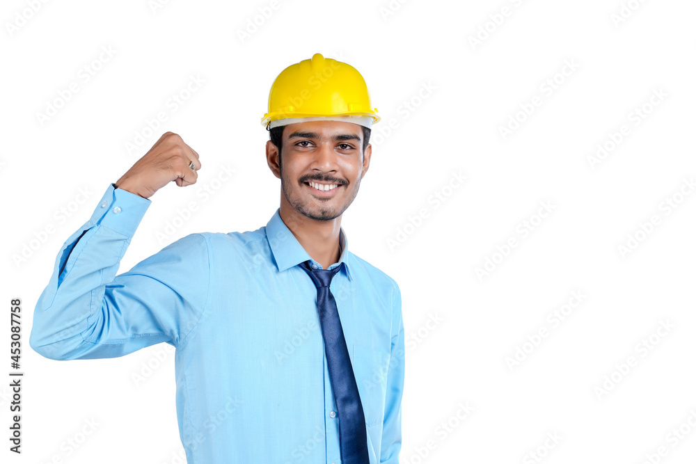 Young Indian engineer wearing yellow color hard hat and giving successful gesture. Young Indian engineer wearing yellow color hard hat and giving successful gesture.
