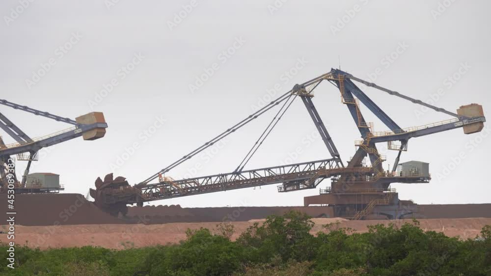 an iron ore stacker loader in operation at port hedland in western australia an iron ore stacker loader in operation at port hedland in western australia